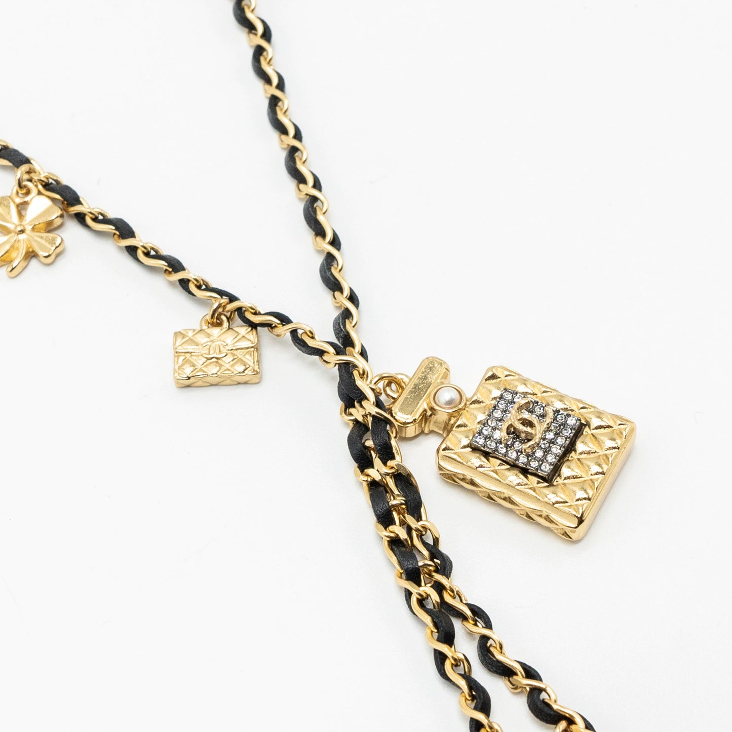 chanel perfume bottle with charm black and gold tone